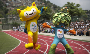 FILE - This is a Monday, Nov. 24, 2014  file photo of the mascots of the Rio 2016 Olympics, left, and Paralympic Games make their first official appearance at a public school in the Santa Teresa neighborhood of Rio de Janeiro, Brazil. The mascot for the 2016 Olympics in Rio de Janeiro has been named as Vinicius, left,  and the Paralympics mascot will go by the name of Tom it was announced Monday Dec. 15, 2014. The names honor Brazilian musicians and partners Vinicius de Moraes and Tom Jobim. They were exponents of Bossa Nova music and creators of the famous song 