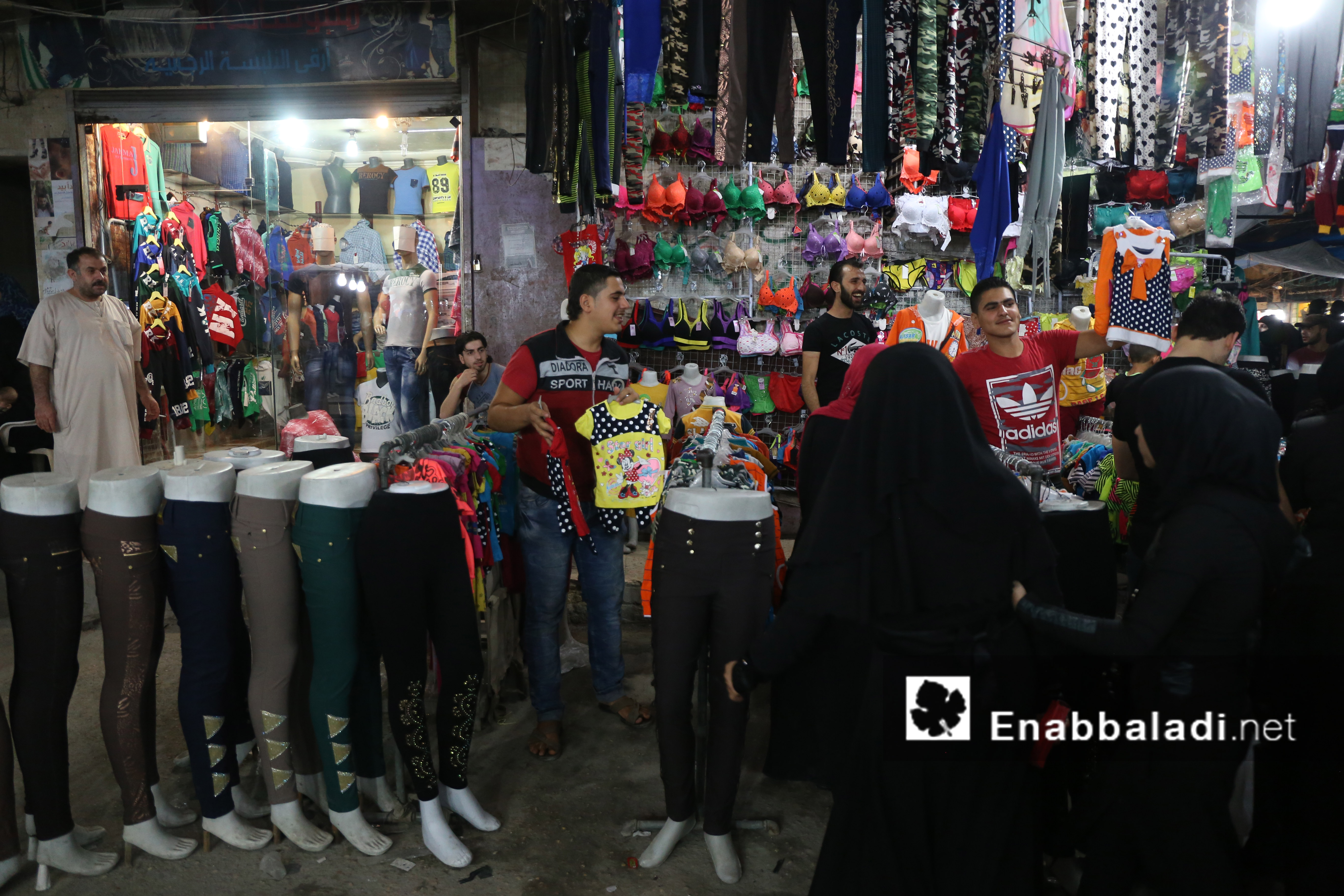 سيدات أمام متجر للألبسة النسائية في أحد أسواق حلب - 4 تموز 2016 (عنب بلدي)