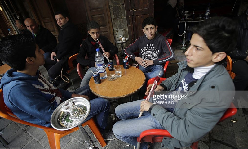 أطفال سوريون في دمشق يدخنون الأركيلة - كانون الثاني 2016 (AFP)