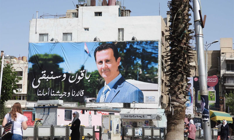 لافتة تحيي رئيس النظام السوري، بشار الأسد، في دمشق (إنترنت)