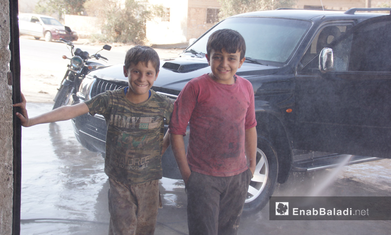 طفلان يعملان في مغسل للسيارات بريف إدلب - تشرين الأول 2016 (عنب بلدي)