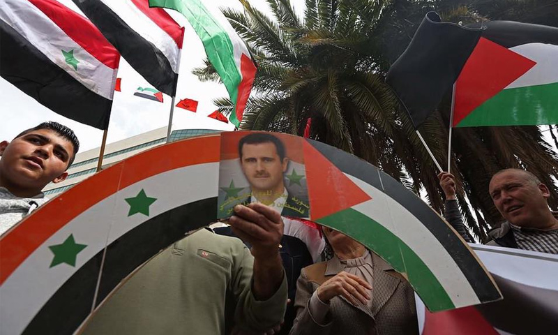 مسيرة مؤيدة لرئيس النظام السوري بشار الأسد- (AFP)