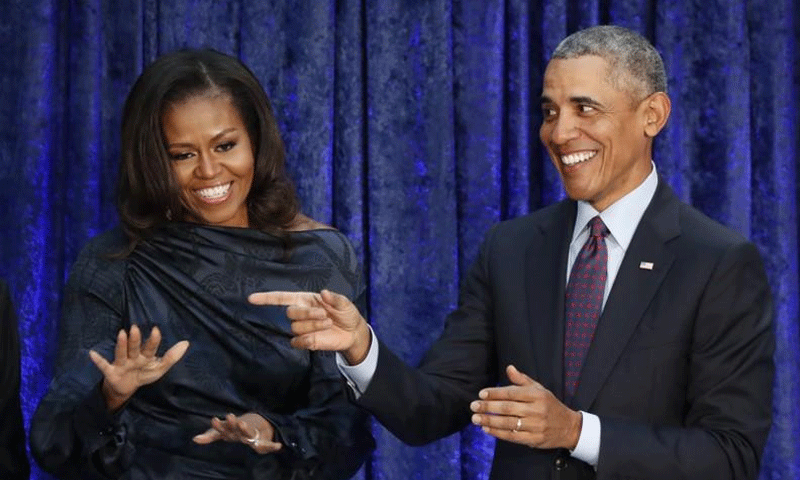الرئيس الأمريكي السابق، باراك أوباما، وزوجته ميشيل أوباما - 12 شباط 2018 (رويترز)