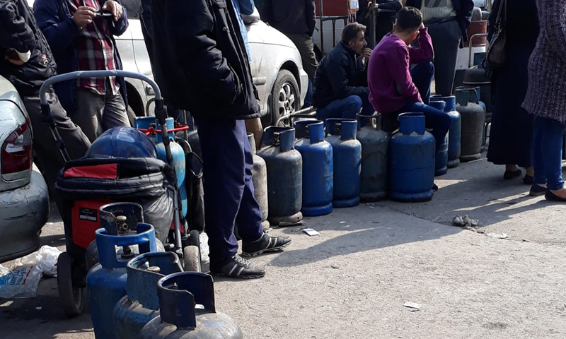 طابور من الأهالي يقفون بانتظار اسطوانات الغاز في دمشق (حازم عوض)