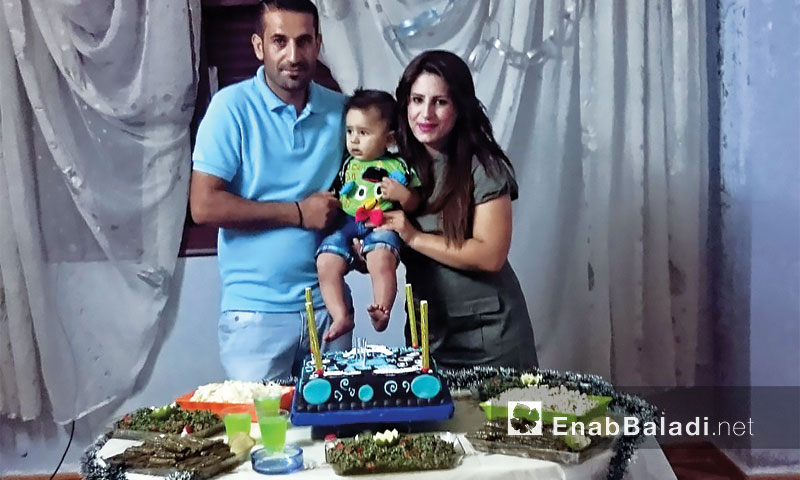 Liwa Souliman with his wife celebrating their son's, Joud, birthday – (Enab Baladi)