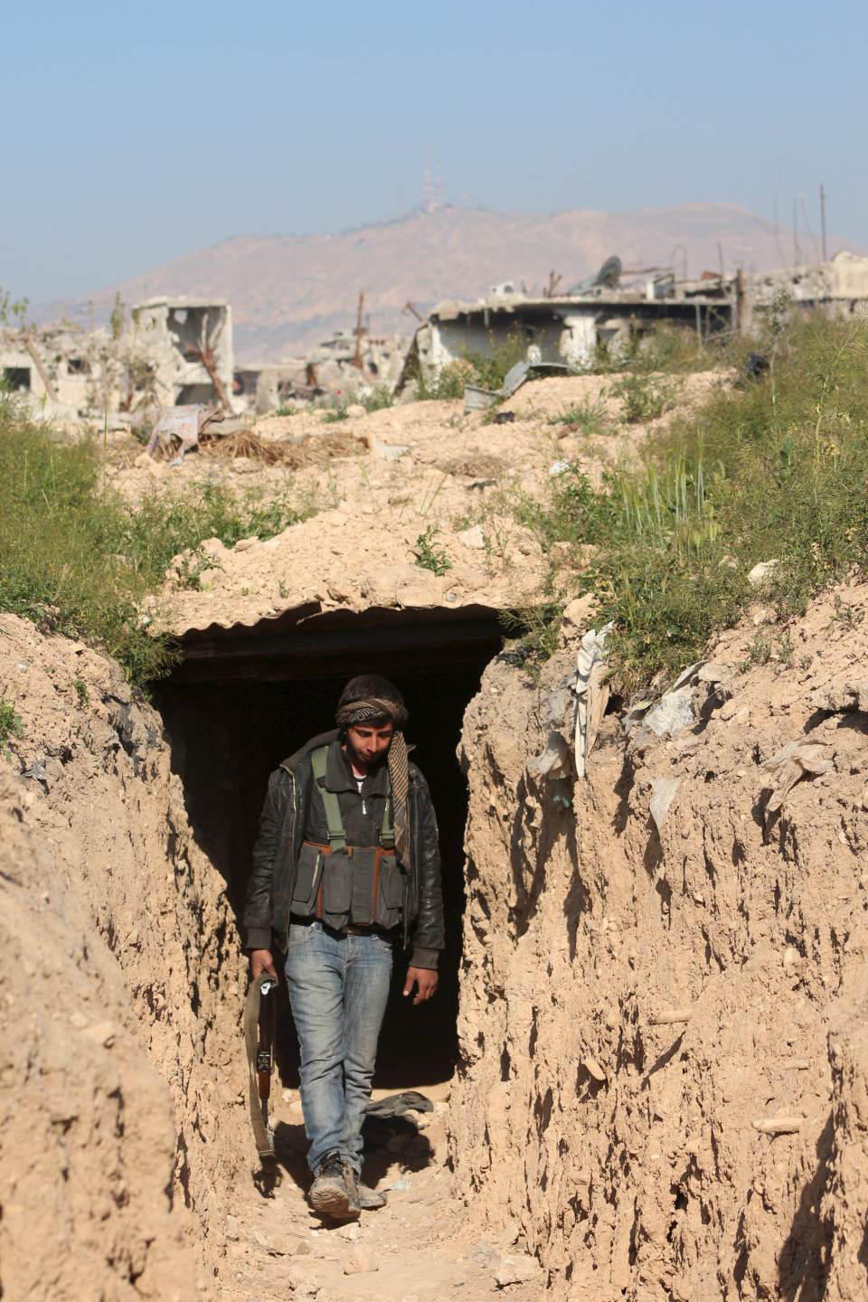A rebel fighter walks out of a tunnel between Ain Tarma and Jobar, in Eastern Ghouta, a suburb of Damascus April 5, 2015 (REUTERS/Diaa Al-Din)