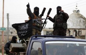 Members of al Qaeda's Nusra Front gesture as they drive in a convoy touring villages, which they said they have seized control of from Syrian rebel factions, in the southern countryside of Idlib, December 2, 2014.
REUTERS/Khalil Ashawi