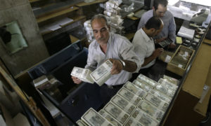 TO GO WITH AFP STORY BY SAMMY KETZ
A banker stacks packed Syrian lira bills at the Central Bank in Damscus on August 25, 2011. US sanctions have forced Syria to stop all transactions in US dollars, with the country turning completely to euro deals, the governor of the Central Bank Adib Mayaleh told the AFP during an interview. AFP PHOTO/JOSEPH EID