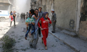 Syrians run for cover amid the rubble of destroyed buildings following a reported air strike on the rebel-held neighbourhood of Al-Qatarji in the northern Syrian city of Aleppo, on April 29, 2016.
Fresh bombardment shook Syria's second city Aleppo, severely damaging a local clinic as outrage grows over an earlier air strike that destroyed a hospital. The northern city has been battered by a week of air strikes, rocket fire, and shelling, leaving more than 200 civilians dead across the metropolis. The renewed violence has all but collapsed a fragile ceasefire deal that had brought an unprecedented lull in fighting since February 27.  / AFP / AMEER ALHALBI        (Photo credit should read AMEER ALHALBI/AFP/Getty Images)