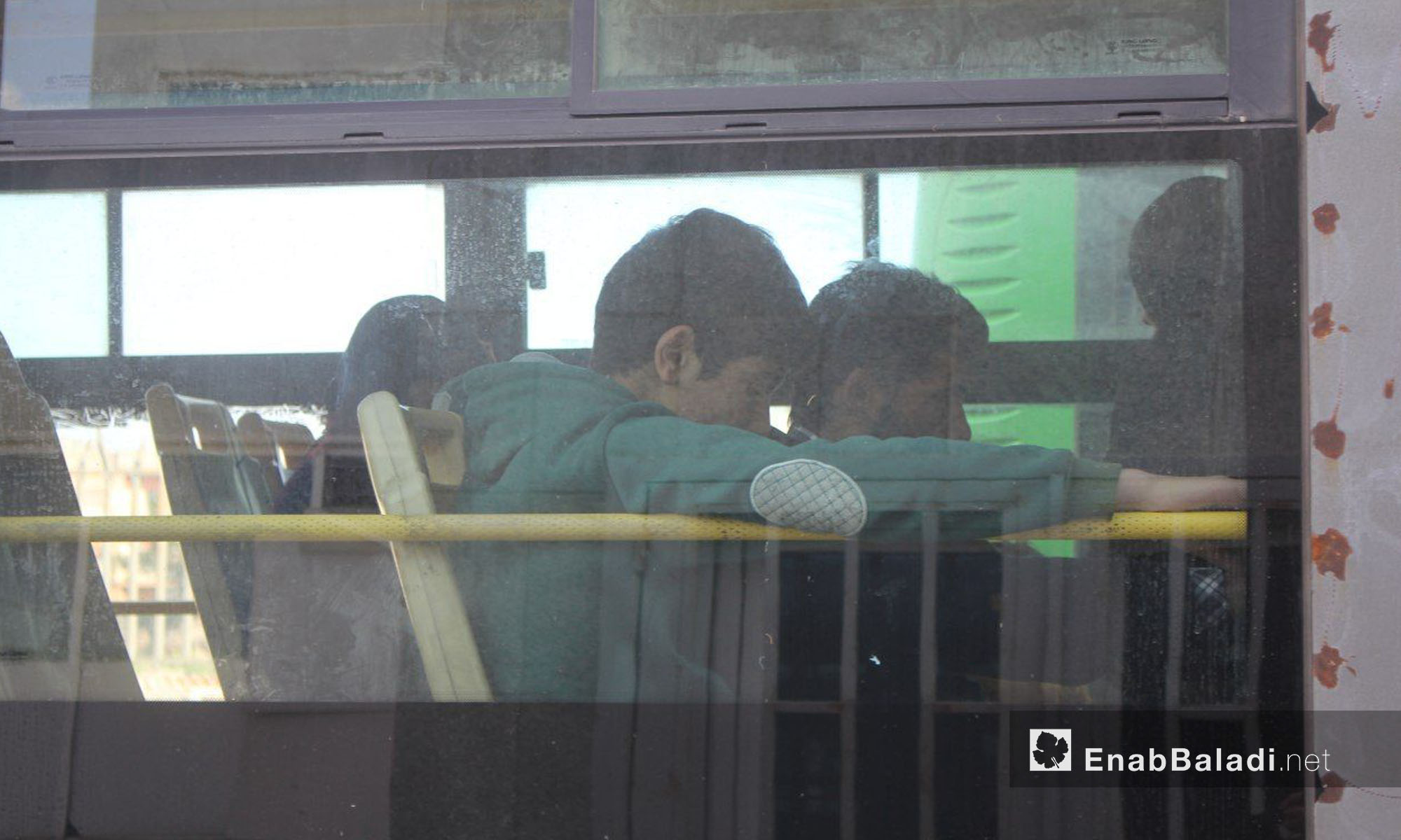 أطفال الوعر ينتظرون في الحافلات قبل الخروج من الحي - 24 نيسان 2017 (عنب بلدي)