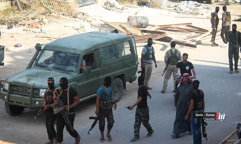 عناصر من فصائل المعارضة أثناء قيامهم بعملية أمنية في مدينة درعا جنوب سوريا - (وكالة نبأ)
