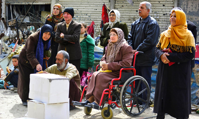مواطنون ينتظرون المساعدات الإنسانية في مخيم اليرموك بدمشق - 15 نيسان 2015 (رويترز)