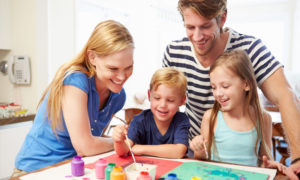 صورة تعبيرية لعائلة تعلم أطفالها على الرسم (FINDING HAPPINESS)