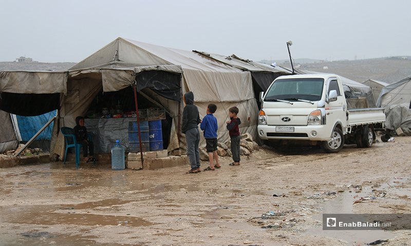 أطفال أمام خيمة لبيع المنتجات الغذائية في مخيم حلب لبيه- 24 من نيسان (عنب بلدي)