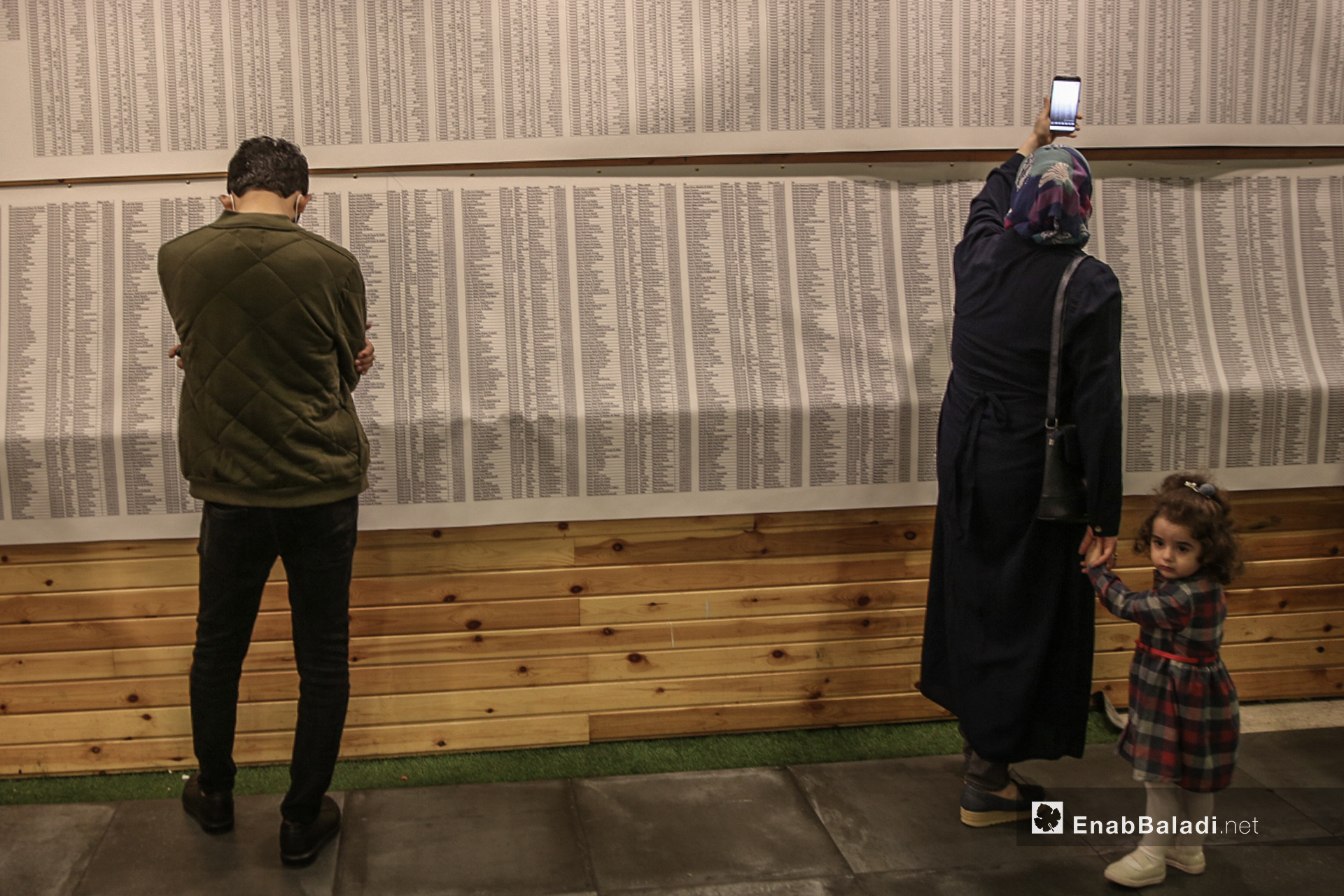 ناشطين في معرض "سُكّان الذاكرة" الذي يوثق بالصور و الاسماء و التواريخ 4600 طفل سوري على لوحة طولها 70 متر في اسطنبول - 13 تشرين أول (عنب بلدي/ عبد المعين حمص)