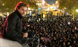 المصور السوري أمير الحلبي أمام مظاهرة في فرنسا (حساب فارس الحلو/ فيس بوك)