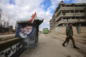 موقع لحاجز أمني تابع لقوات النظام السوري بجانب أبنية مدمرة في مدينة حلب- 3 من كانون الأول 2016 (AFP)
