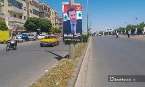 لافتة تحمل صورة رئيس النظام السوري بشار الأسد تدعو المواطنين لإعادة انتخابه - 12 أيار 2021 (عنب بلدي/ عروة المنذر)