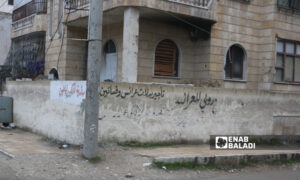 أحد الإعلانات المنتشرة في شوارع مدينة إدلب- 18 كانون الأول 2021 (عنب بلدي)