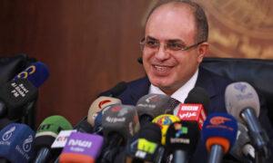 وزير الاقتصاد والتجارة الخارجية السوري محمد سامر الخليل يعقد مؤتمراً صحفياً في دمشق -13 تشرين الأول 2021 (AFP) 
