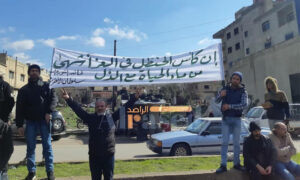 متظاهرون يرفعون لافتات في ساحة المدينة احتجاجًا على قرارات صادرة عن حكومة النظام السوري- 11 شباط 2022 (السويداء 24)