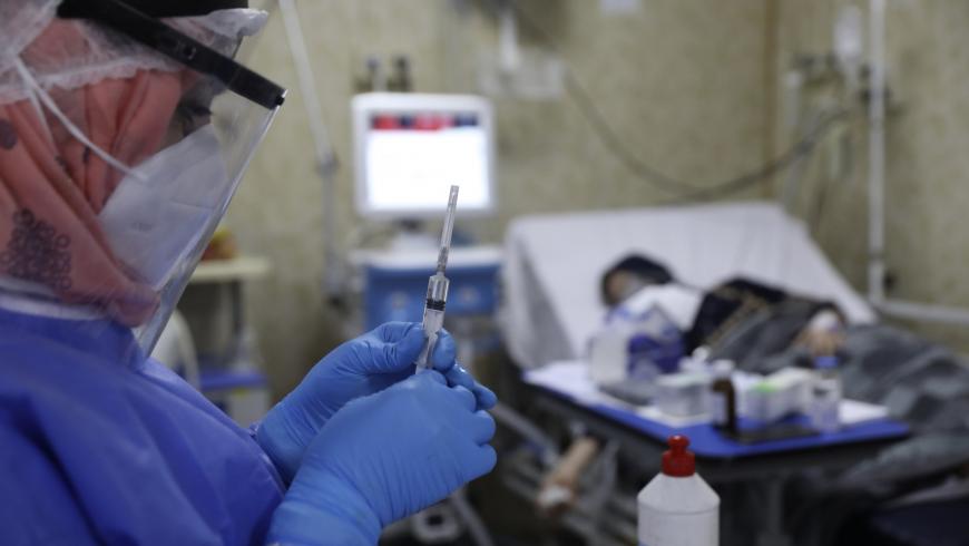 ممرضة تحضر حقنة لمريض مصاب بفيروس كورونا في وحدة العناية المركزة بمستشفى الجمعية الطبية السورية الأمريكية في مدينة إدلب - 20 من أيلول 2021 (AFP)