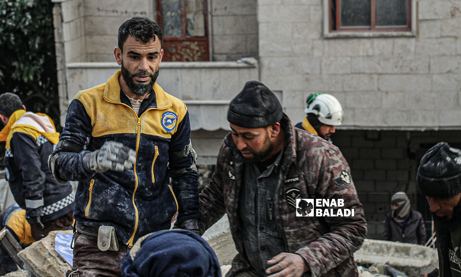 متطوعون ومدنيون في شمال غربي سوريا، يحاولون إنقاذ المصابين وانتشال الضحايا تحت الركام في جنديرس إثر الزلال - 7شباط 2023 (عنب بلدي/ ديان جنباز)