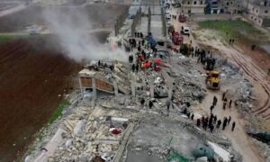 عمال الإنقاذ يبحثون بين أنقاض المباني المنهارة في أعقاب الزلزال في قرية سرمدا بريف إدلب - 6 شباط 2023 (رويترز)