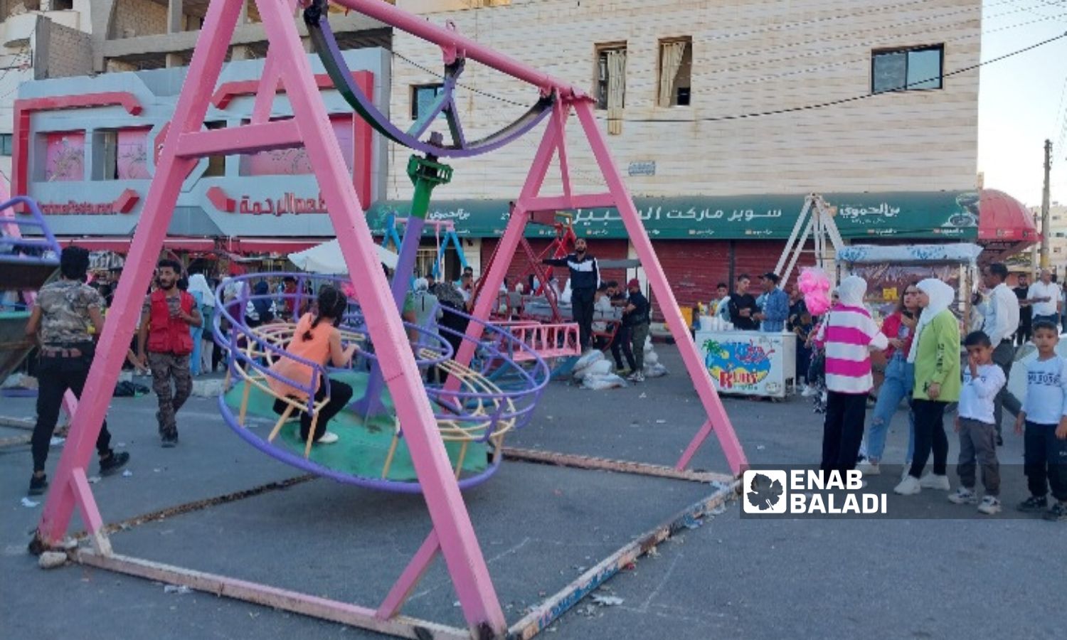 أطفال يلعبون على الأراجيح في أحياء درعا المحطة بمدينة بدرعا - 29 من حزيران 2023 (سارة الأحمد عنب بلدي)