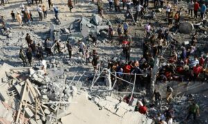 فلسطينيون في غزة يبحثون عن ضحايا تحت الأنقاض في أعقاب غارات إسرائيلية في خان يونس جنوبي قطاع غزة- 14 من تشرين الأول 2023 (رويترز)