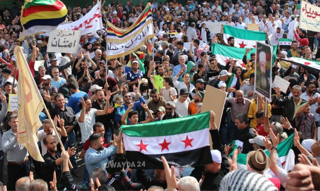 محتجون في ساحة الكرامة وسط السويداء يرفعون علم الثورة السورية، ويطالبون بإسقط النظام- 10 من تشرين الثاني 2023 (السويداء 24/ فيس بوك)