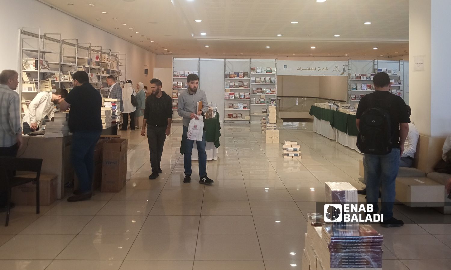 زوار داخل صالة معرض "كتب المركز العربي واصداراته بدمشق" - 28 نيسان 2025 (عنب بلدي/مارينا مرهج)