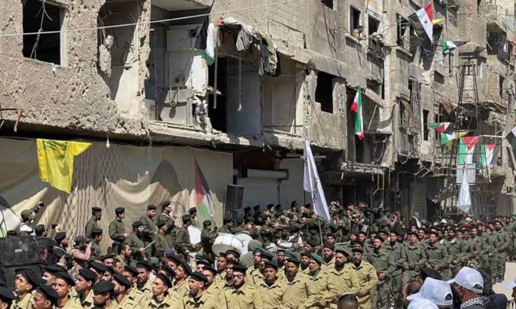 عرض عسكري لفصائل فلسطينية في مخيم اليرموك جنوبي دمشق- 14 من نيسان 2023 (سبوتنيك)