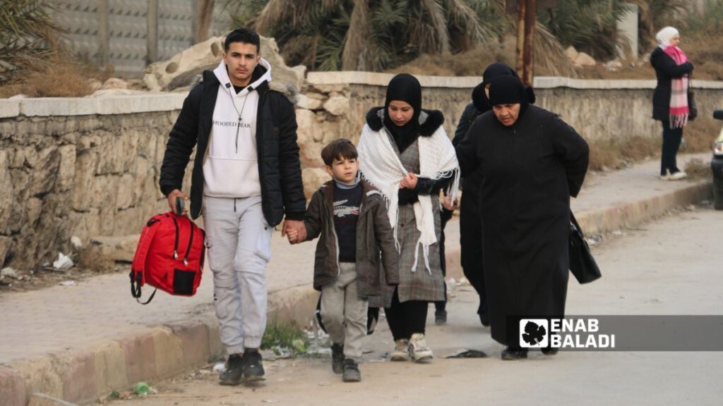 خروج الأهالي من حي الشيخ مقصود والاشرفية في مدينة حلب- 23 كانون الأول 2025 (عنب بلدي/ محمد مصطو)
