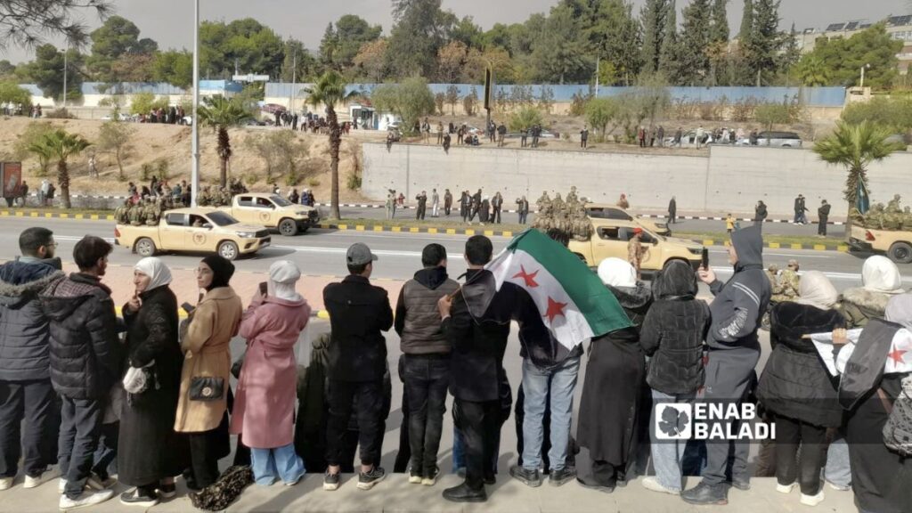 سوريون يشاهدون العرض العسكري في دمشق بذكرى التحرير الأولى – 8 كانون الأول 2025 (عنب بلدي/ نور حمزة)