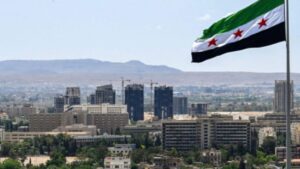 العلم السوري يرفرف فوق حديقة الأمويين (تشرين سابقًا) في دمشق (AFP)