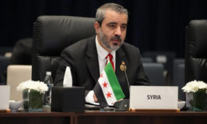 وزير الخارجية السوري أسعد الشيباني يلقي كلمة سوريا في الدورة الـ52 لمجلس وزراء خارجية دول منظمة التعاون الإسلامي في العاصمة العراقية بغداد - 17 تشرين الأول 2026 (وزارة الخارجية السورية)

