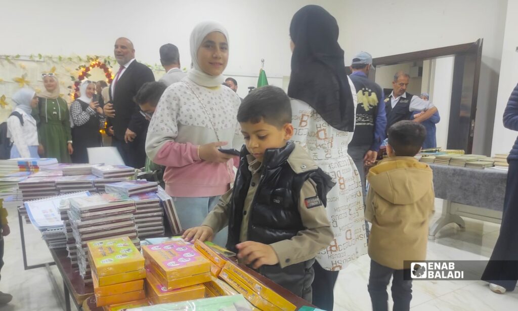 طلاب وزوار يتصفحون كتبًا ضمن معرض الكتاب في المركز الثقافي بمدينة داري