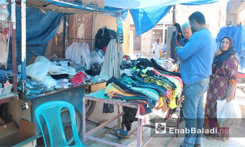 Clothes' trader in the market of Qamishli city – September, 29th, 2016 (Enab Baladi)