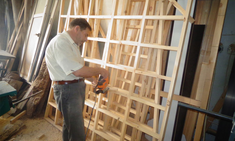 A displaced man from Rif-Dimashq is working in carpentry in Al-Suwayda