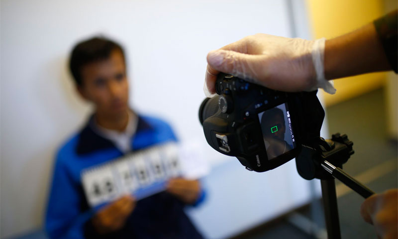 Taking a picture of a refugee in an immigrants camp, Germany (Reuters)