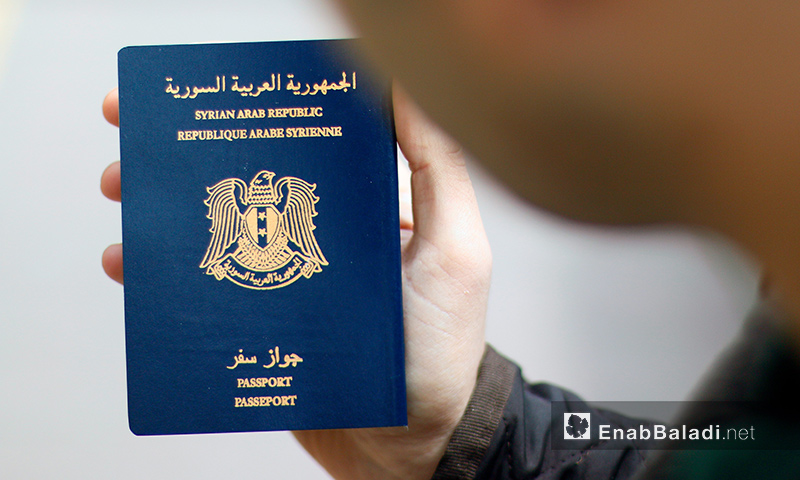 A Syrian refugee carrying his passport in Istanbul, Turkey (Enab Baladi)