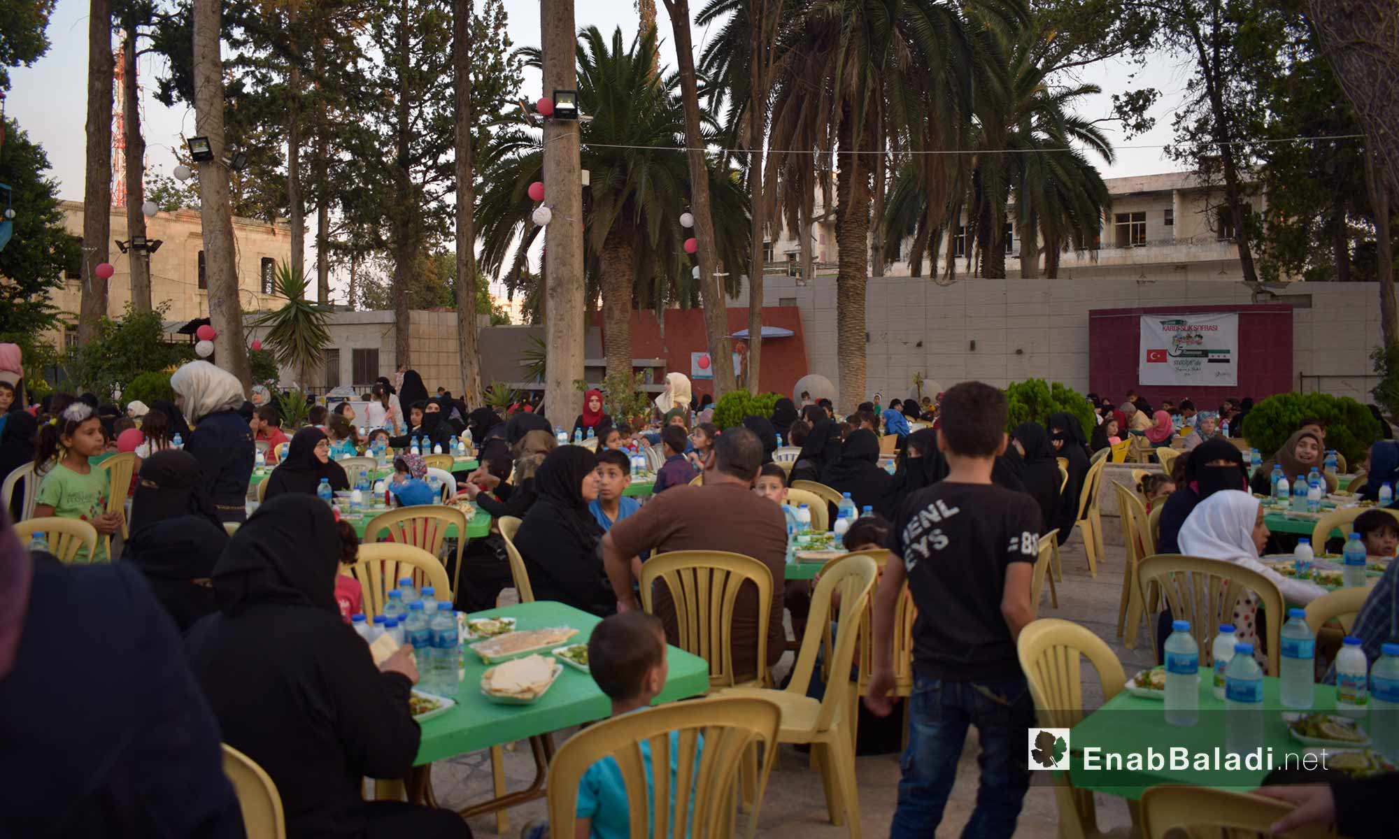 The orphans and their mothers having the Iftar meal at the Family Club in Idlib – May 30, 2018 (Enab Baladi)