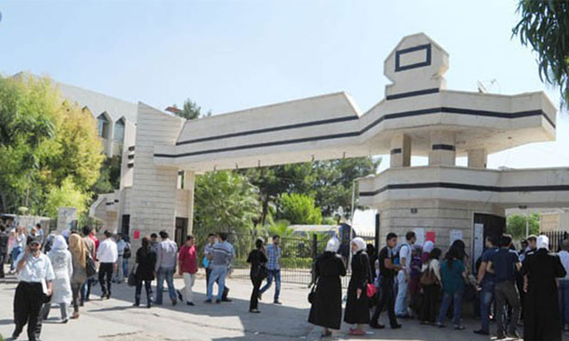 Students at the gate of the College of Arts and Humanities, Damascus University (SANA)