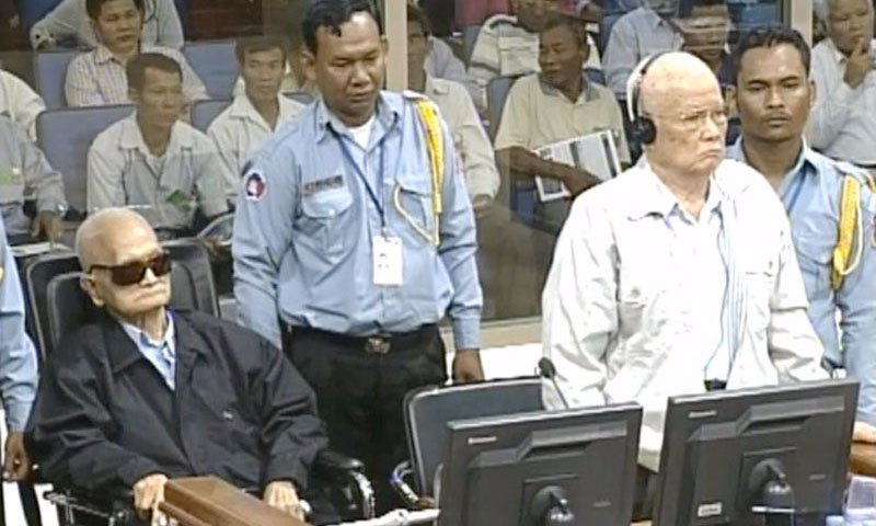 Former Khmer Rouge leaders Nuon Chea, left, and Khieu Samphan appear on Thursday in the dock of the Khmer Rouge tribunal, where they were found guilty of crimes against humanity and sentenced to life in prison. (Video still courtesy of the Extraordinary Chambers in the Courts of Cambodia) - November 22, 2018 (The Cambodian Daily)