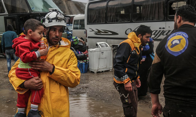 Civil Defense members while evacuating an opposition-controlled area