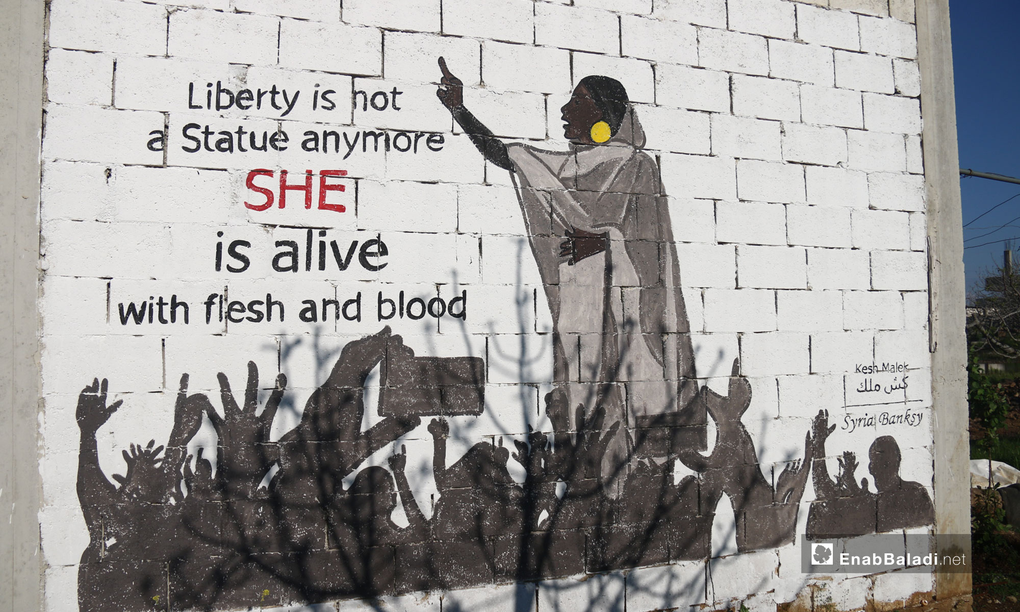 A mural in southern Idlib symbolizing the role of women in the Sudanese revolution – April 11, 2019 (Enab Baladi)
