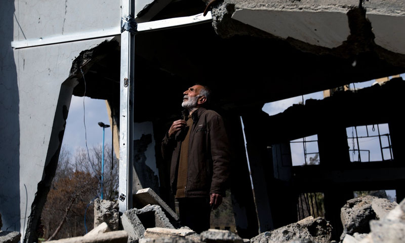 Afandi Abu Saow, Armenian Christian, standing near the remains of an Armenian church I Raqqa, which received several aerial attacks during the prayers – 24 February, 2018 (NurPhoto)