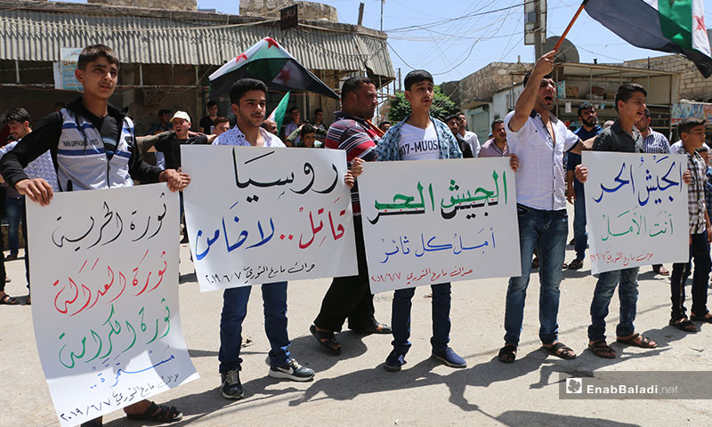 A demonstration in the city Marea, northern rural Aleppo. The signs carried by the demonstrators say: “You Are The Hope, Free Army!/ Russia, A Murderer, Not a Guarantor/ The Free Army Is The Hope for Every Revolutionary/ The Revolution of Freedom, The Revolution of Justice, The Revolution Of Dignity, Is Ongoing” – June 7, 2019 (Enab Baladi)

