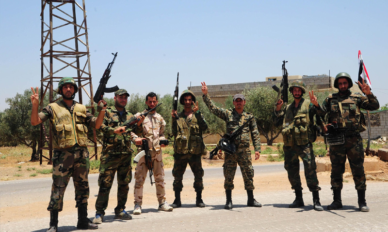 Assad Forces’ personnel taking a photo in rural Daraa – July 2018 (Reuters)